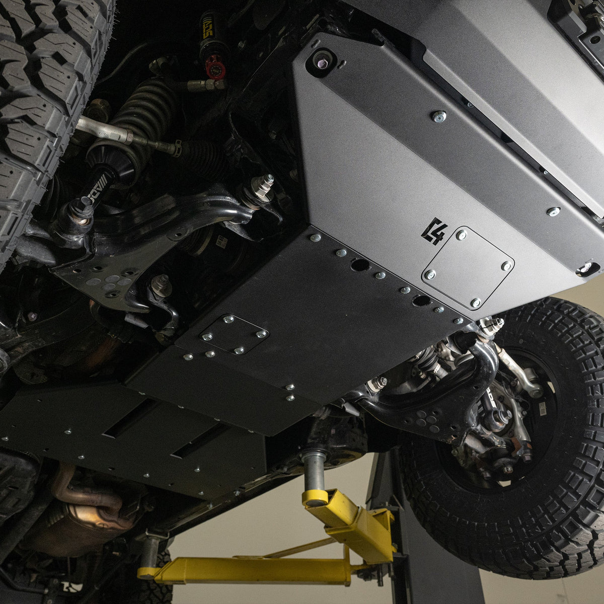 C4 Skid Plates for the 6th Gen 4Runner, taken on the lift. Rear skid is visible as well.