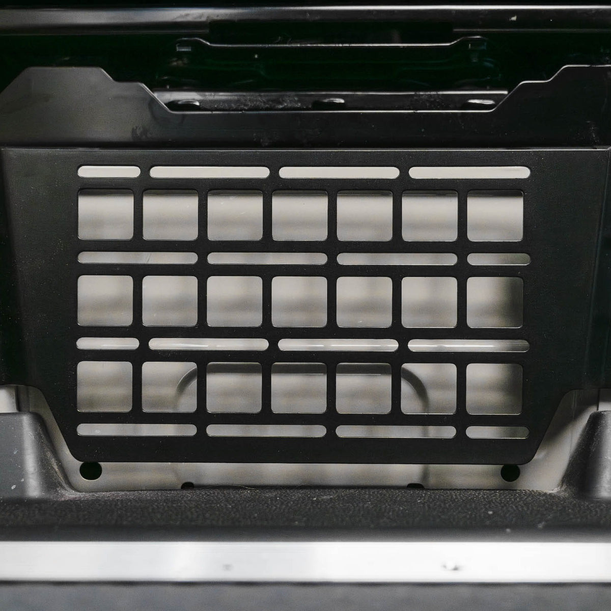 Close front view of installed Sprinter Van Seat Base Molle Panel for added storage