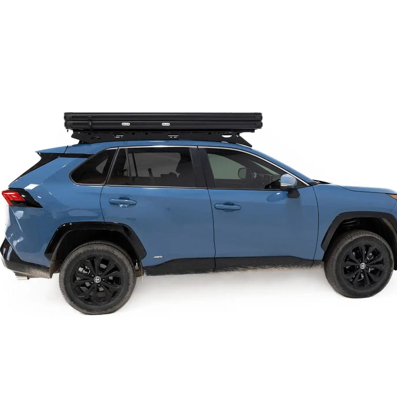Side profile photo of the FSR Aspen Lite Standard Rooftop Tent when closed and mounted on a blue Toyota Rav4.