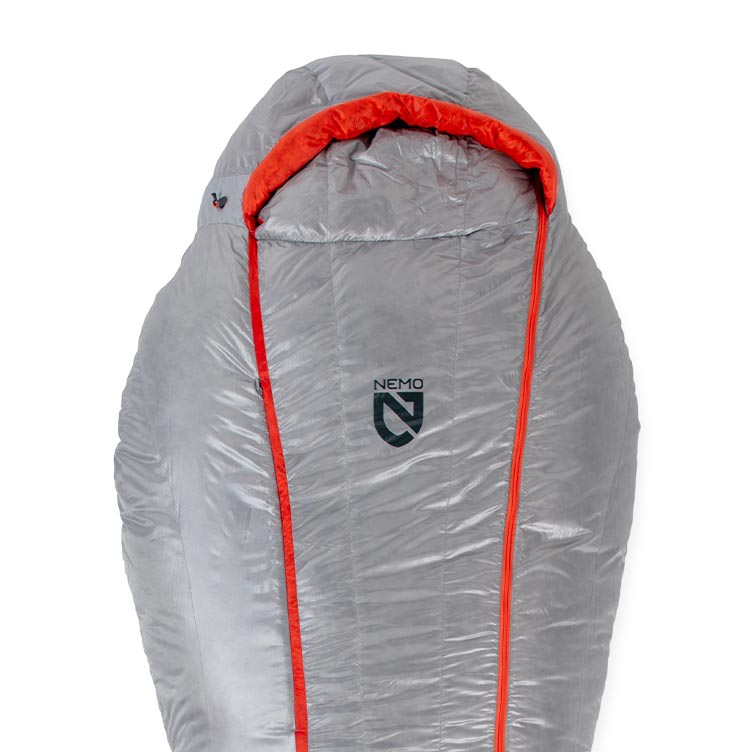 A gray NEMO Equipment Coda™ Endless Promise® Down Mummy Sleeping Bag with an orange interior lining and zipper, featuring the NEMO logo on the front.