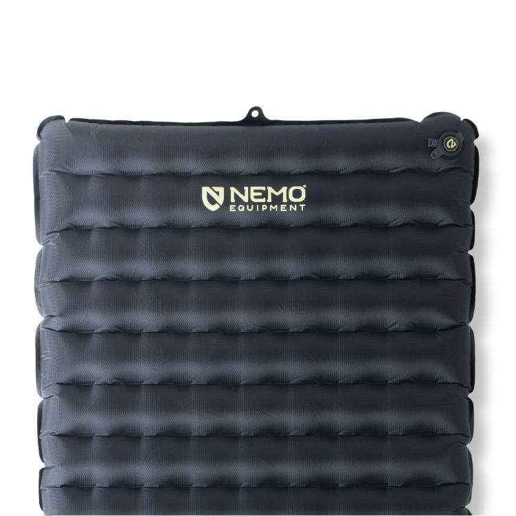 The Tensor™ Extreme Conditions Ultralight Insulated Sleeping Pad by NEMO Equipment is a dark gray pad with horizontal air chambers, upper right valve, and features Thermal Mirror film for superior warmth on chilly nights.
