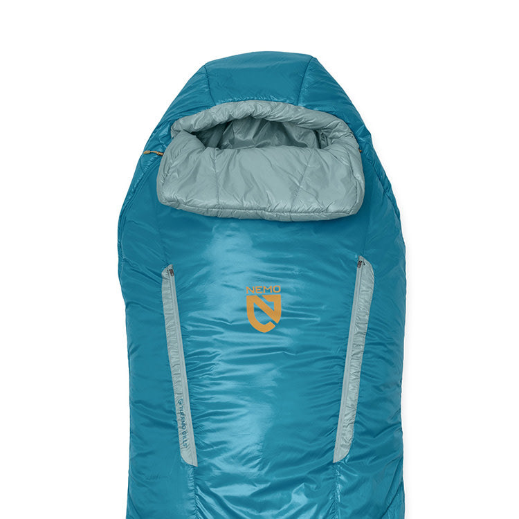 The Forte™ Endless Promise® Women's Synthetic Sleeping Bag by NEMO Equipment is a teal and light gray 3-season bag with a hood, two vertical side zippers, and the NEMO logo on the front.
