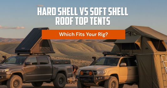 Two overland trucks side by side at a desert camp — wedge hard-shell rooftop tent open on the left, fold-out soft-shell tent with annex on the right. TerrainVault comparison guide hero.