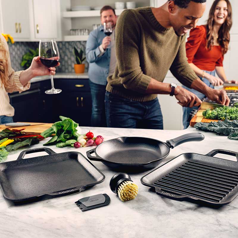 A group of friends cooking with set and preparing ingredients.