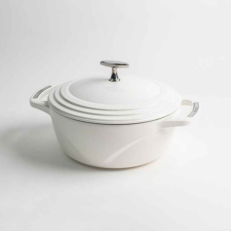 White enameled cast iron Dutch oven with a lid on a white background