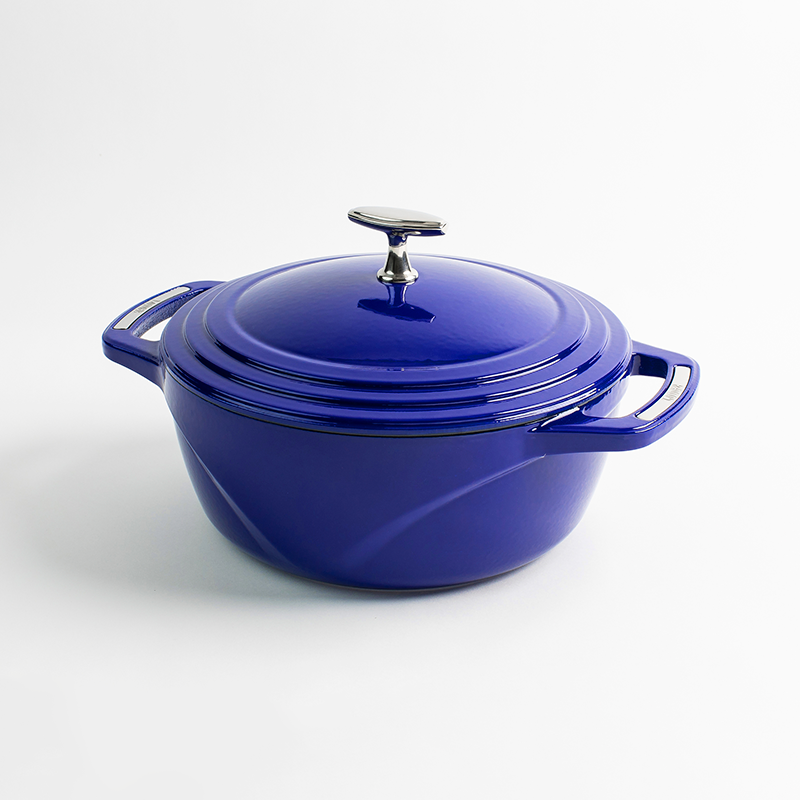 Blue enameled cast iron Dutch oven with a lid on a white background