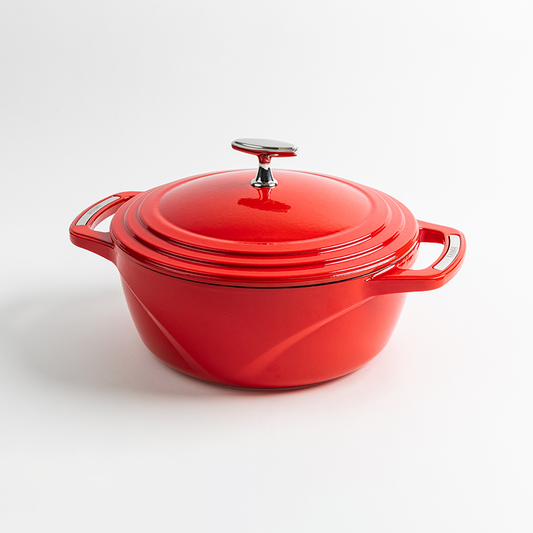 Red enameled cast iron Dutch oven with a lid on a white background