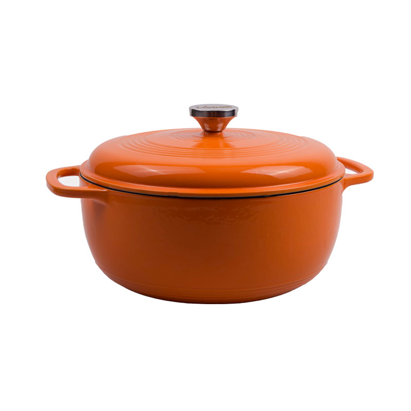 Pumpkin enameled cast iron Dutch oven with lid on a white background