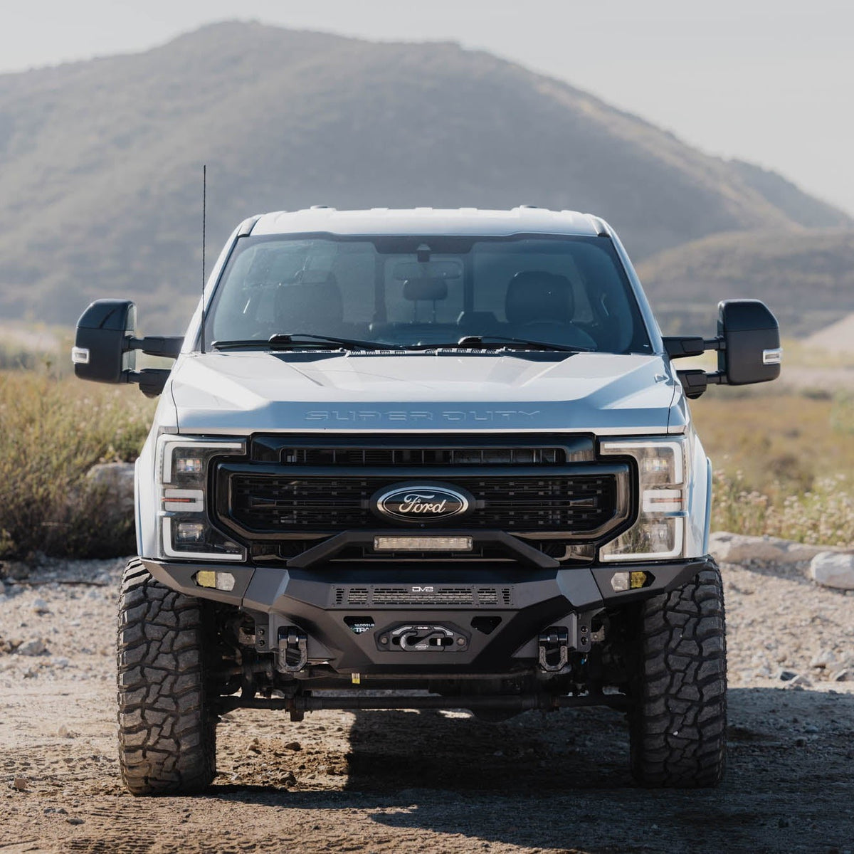 Spec Series Front Bumper for the 2017-2022 Ford F-250/350 on a dirt road with mountains in the background