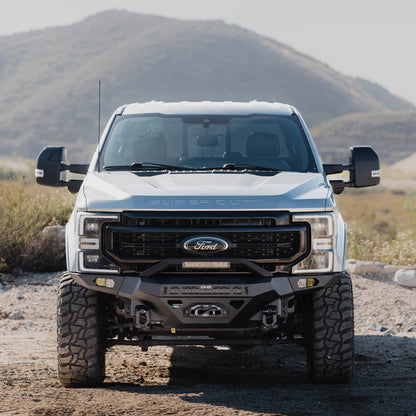 Spec Series Front Bumper for the 2017-2022 Ford F-250/350 on a dirt road with mountains in the background