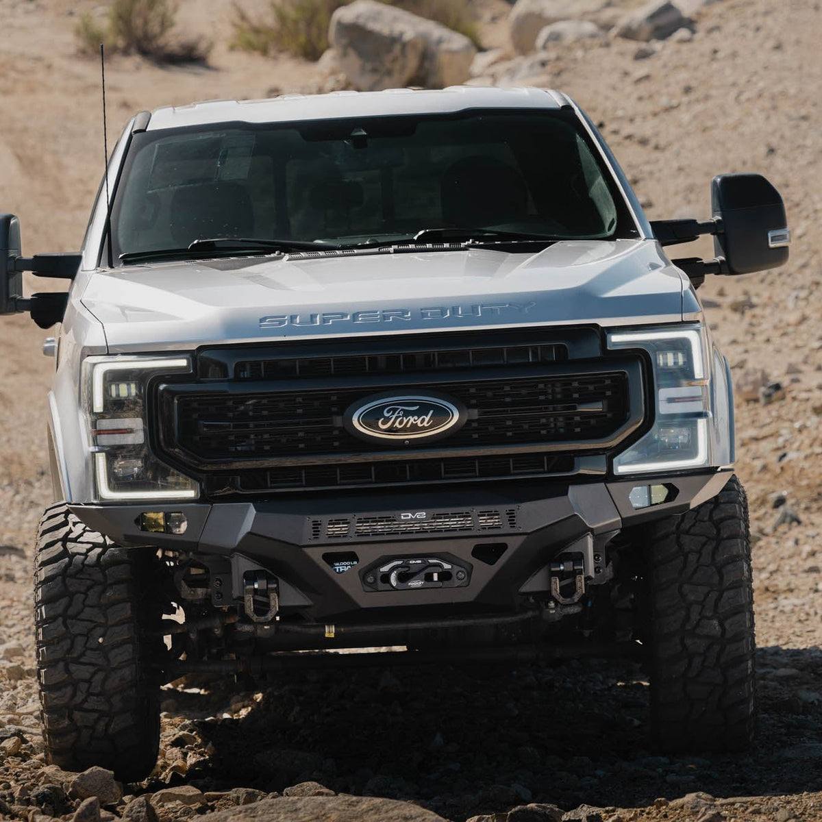 Spec Series Front Bumper for the 2017-2022 Ford F-250/350 on a dirt road with a desert landscape