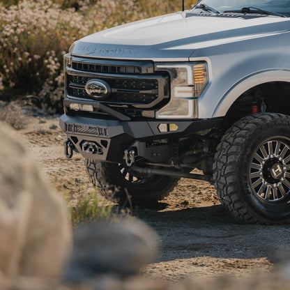 Spec Series Front Bumper for the 2017-2022 Ford F-250/350 on a dirt road with natural surroundings