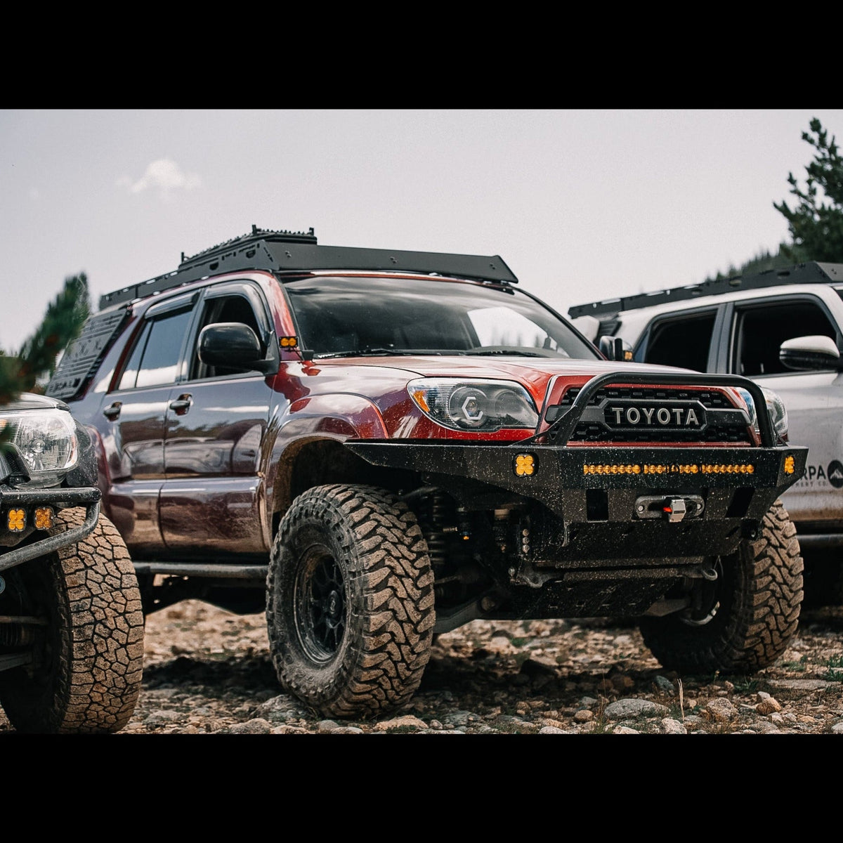 Close-up of a maroon 4Runner Overland Series Front Bumper 4th Gen 2003-2009