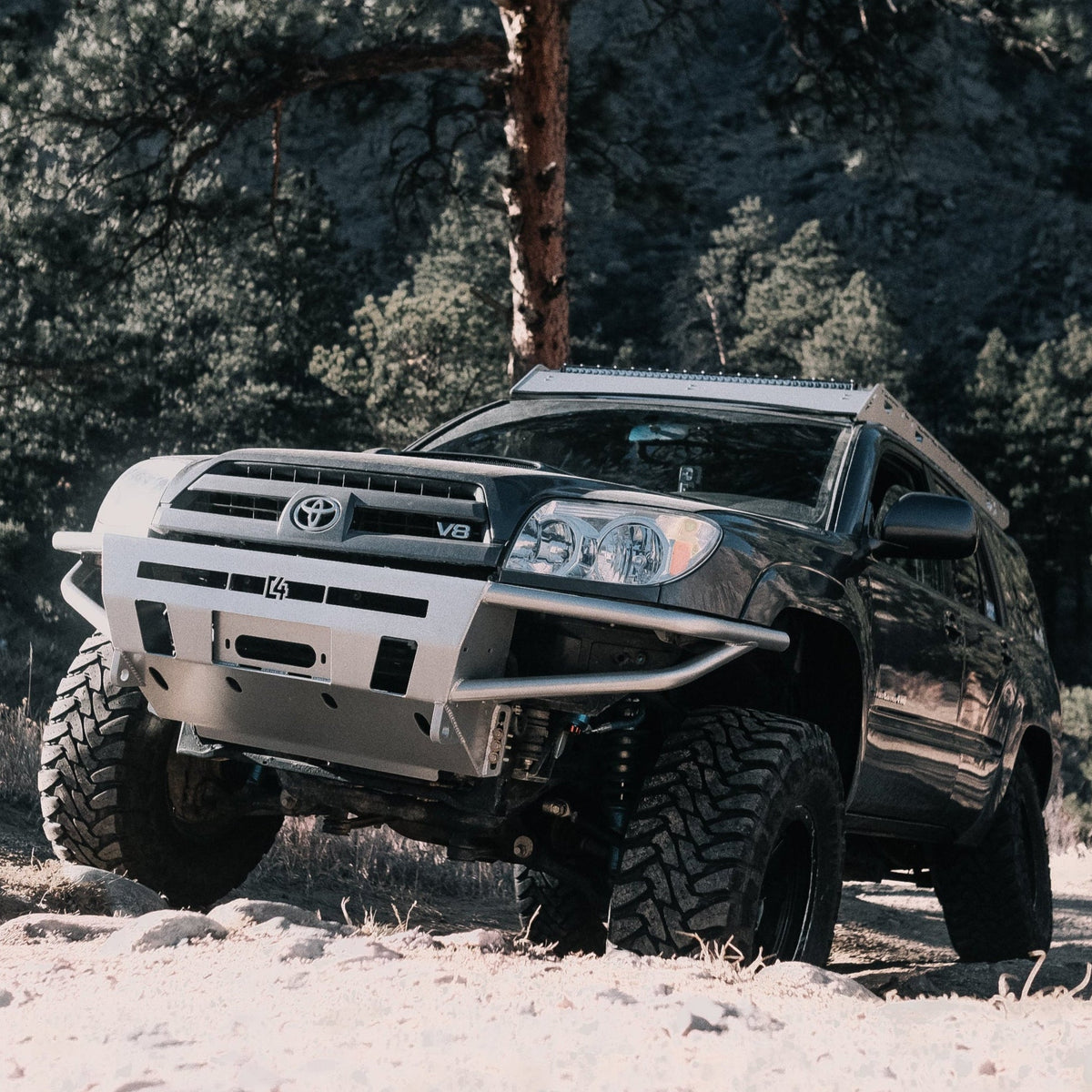 V8 4Runner climbing a mountain trail and equipped with a C4 winch bumper.