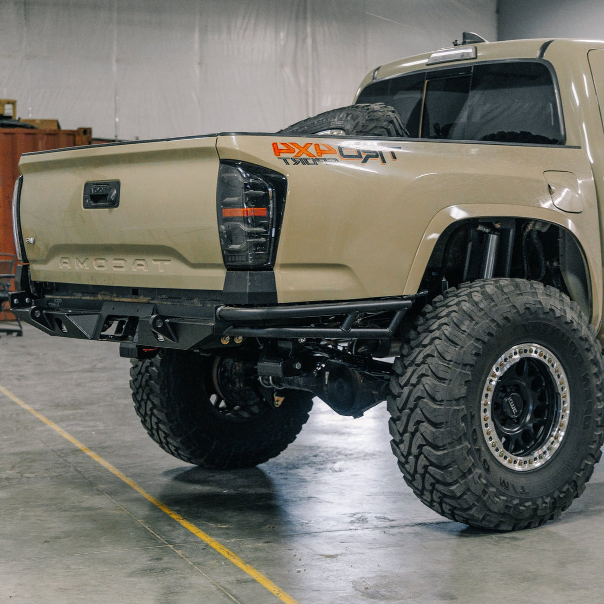 C4 Rock Runner High Clearance Rear Bumper with double tube sides installed on a tan Tacoma.