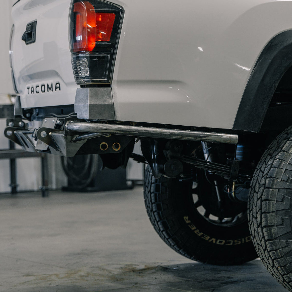 Close-up side view of the C4 Rock Runner High Clearance rear bumper with the single slant tube side wing.