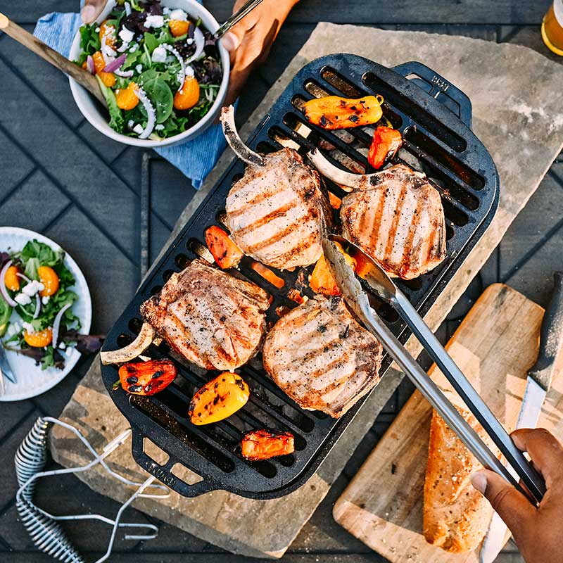 Freshly grilled pork and peppers on grill.
