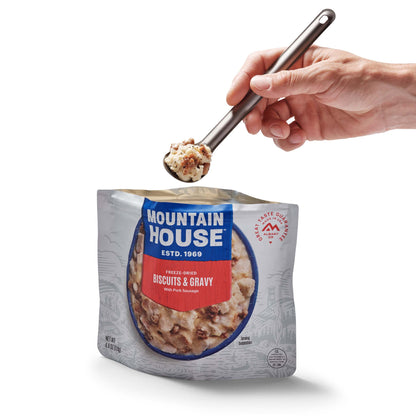 Person scooping out spoonful of Mountain House Biscuits & Gravy from pouch.