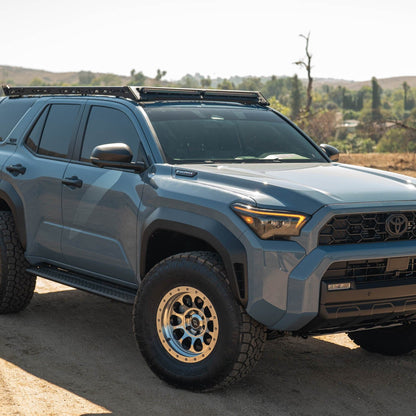 6th Gen Toyota 4Runner Roof Rack Light Cutout installed on a dirt road with a scenic background
