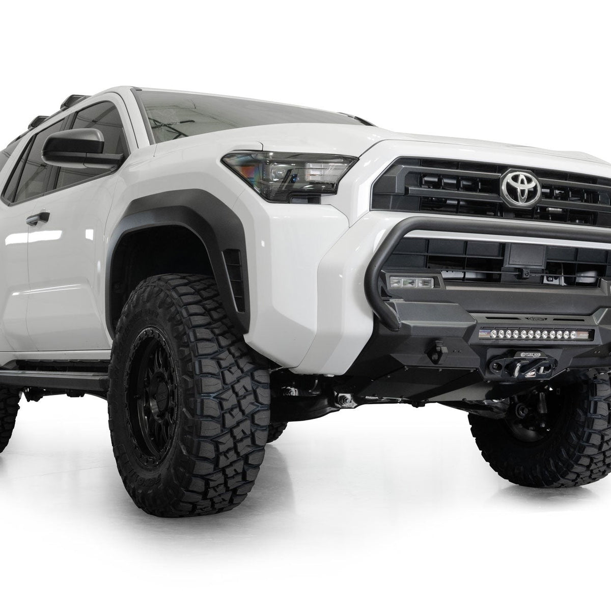 2025 Toyota 4Runner Stealth Center Mount Front Bumper with Top Hoop with lifted suspension and off-road tires on a white background