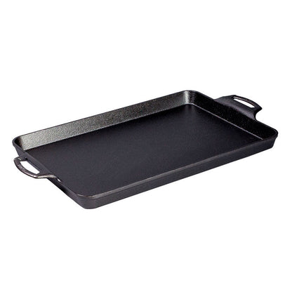 Black cast iron, rectangular pan with handles and shallow edges.