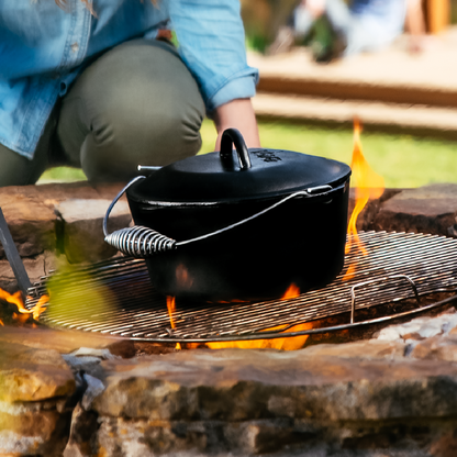 Dutch oven being used over fire.