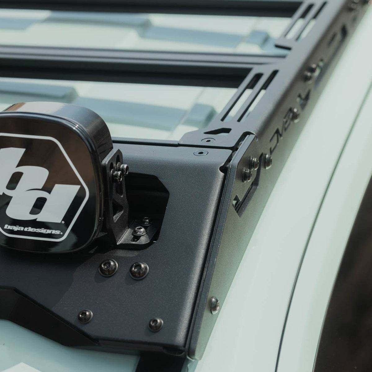 Baja Designs Linkable Lightbar Mount for DV8 Roof Rack Light Option installed on vehicle roof rack with Baja Designs off road lights