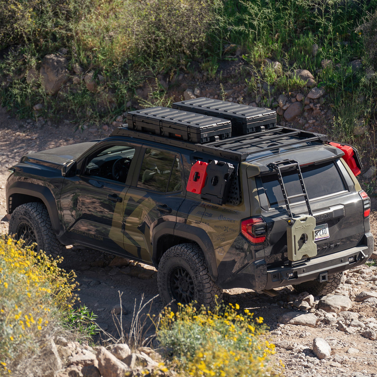 High-angle view of the C4 4Runner build, equipped with bumpers, roof rack, ladder, and MOLLE panels.