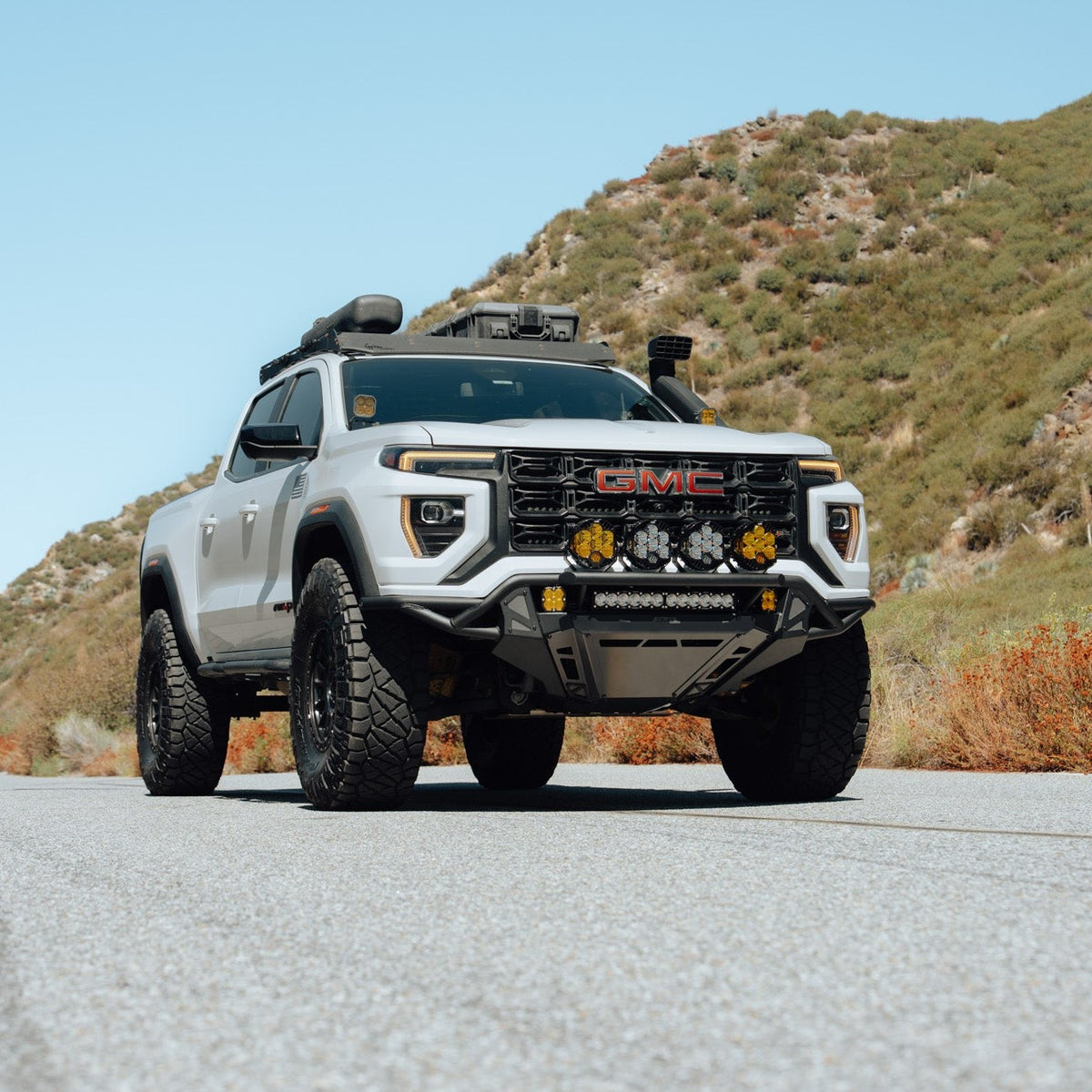 GMC Canyon Tube Front Bumper installed on off road rig with ultra-high clearance and integrated skid plate