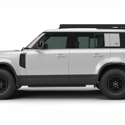 A white Land Rover Defender 110 with black wheels, black trim, and a roof rack, shown in a side profile view against a plain white background with a Leitner Designs ACS ROOF Platform Rack.