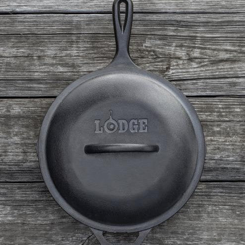 Top view of lid on skillet, displaying branding and handle.