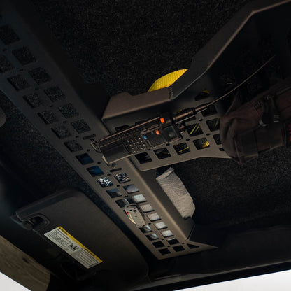 Overhead Molle Storage Panel for 2007-2018 Jeep Wrangler JK with CB radio and knife holder installed, and items stored above the panel