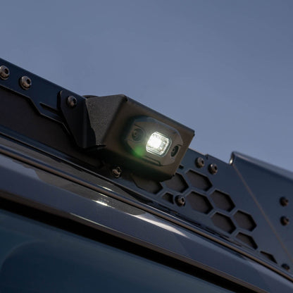 DV8 Micro Elite Utility Light mounted on roof rack to illuminate the side of the vehicle