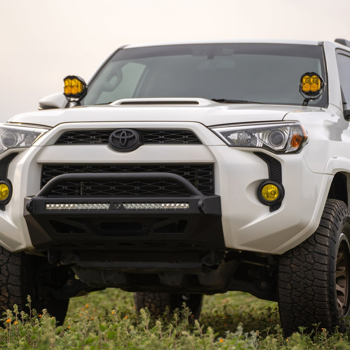 5th Gen Toyota 4Runner Ditch Light Brackets, installed on 4 runner parked in grassy field