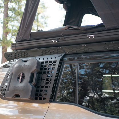GX 550 fully equipped on camping trip with roof rack, roof-top tent, and our exterior molle panels