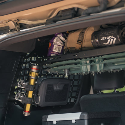Flashlight mounted to the rear molle panels using quick fists.