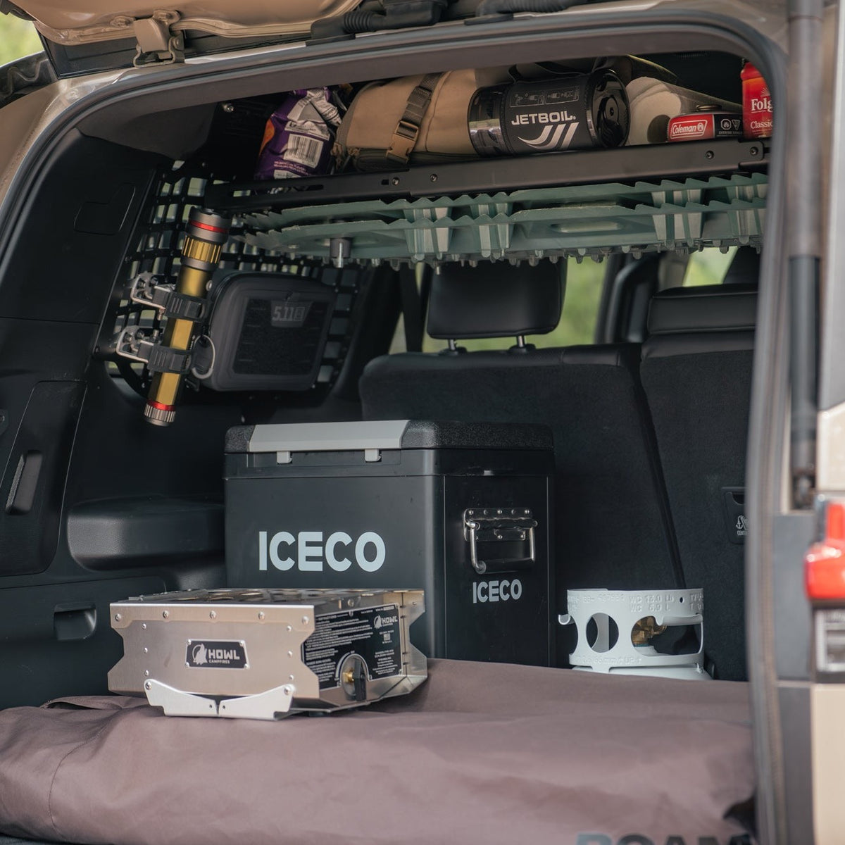 Tools and food mounted to the molle panel windows and shelf to make room for heavier camping cooler and stove in the cargo area.