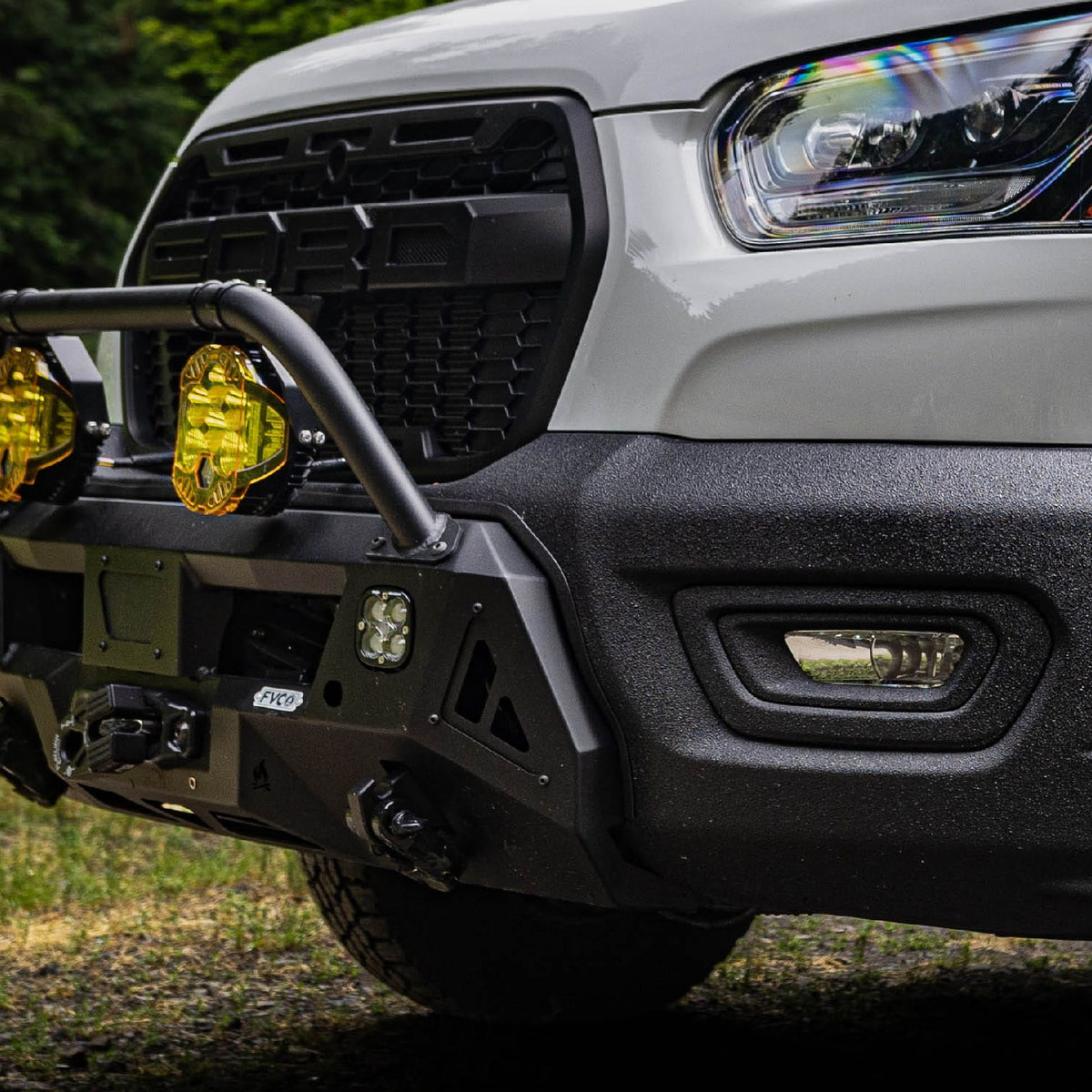 Close view of Transit Core Front Bumper installed with Bull Bar option and auxiliary off road lighting