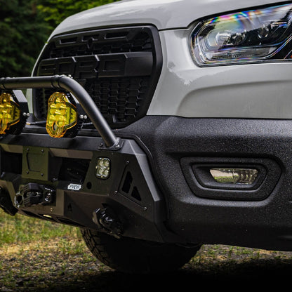 Close view of Transit Core Front Bumper installed with Bull Bar option and auxiliary off road lighting