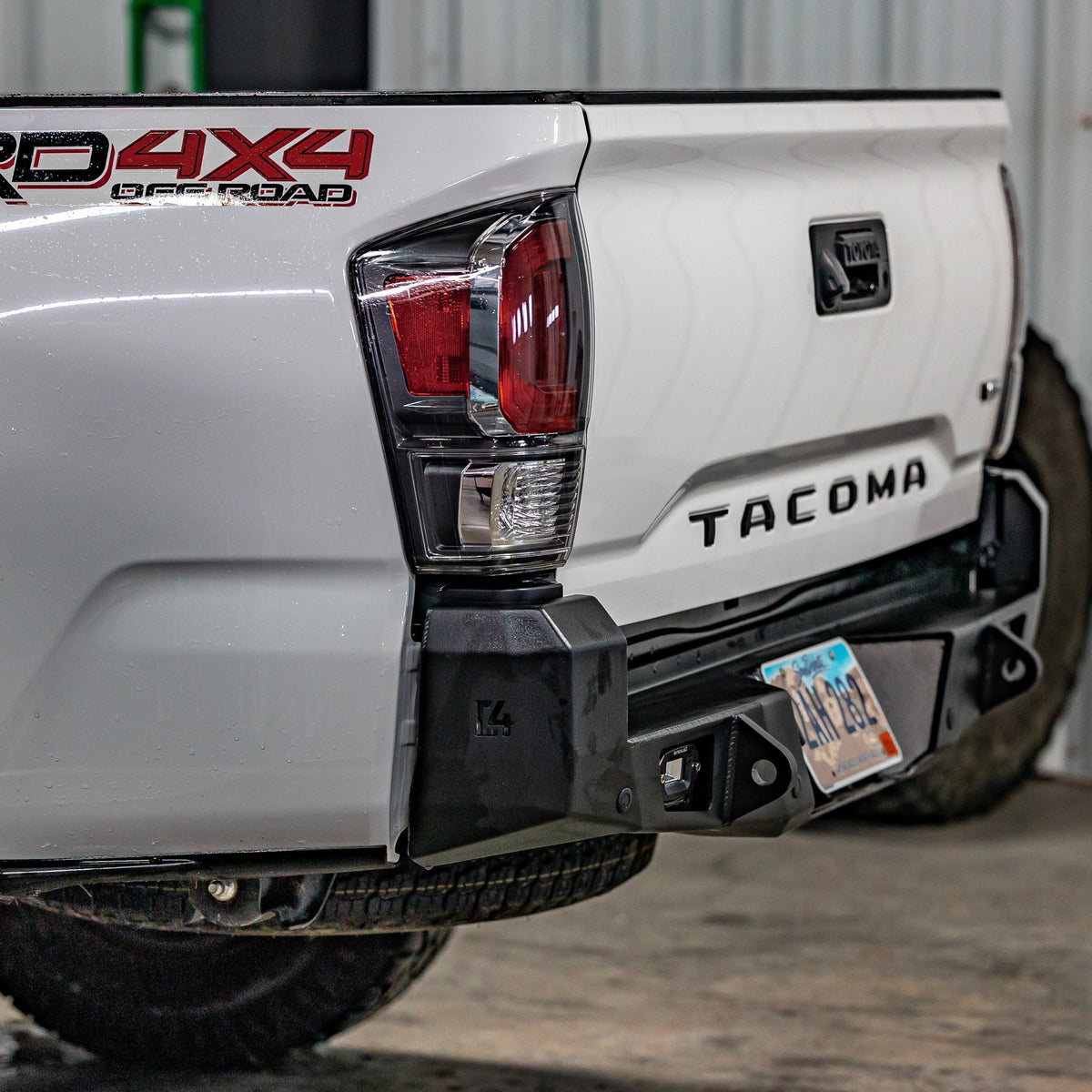 Quartering view of the C4 Overland Rear Bumper installed on a White TRD Off-Road Tacoma.