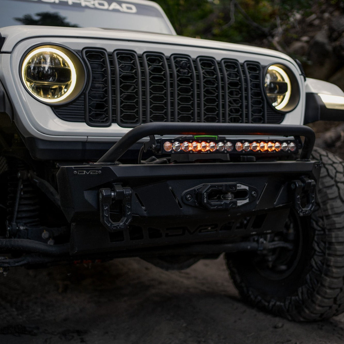 Front view of Jeep driving the trails with Spec Series bumper and the Universal Spec Series Bull Bar installed