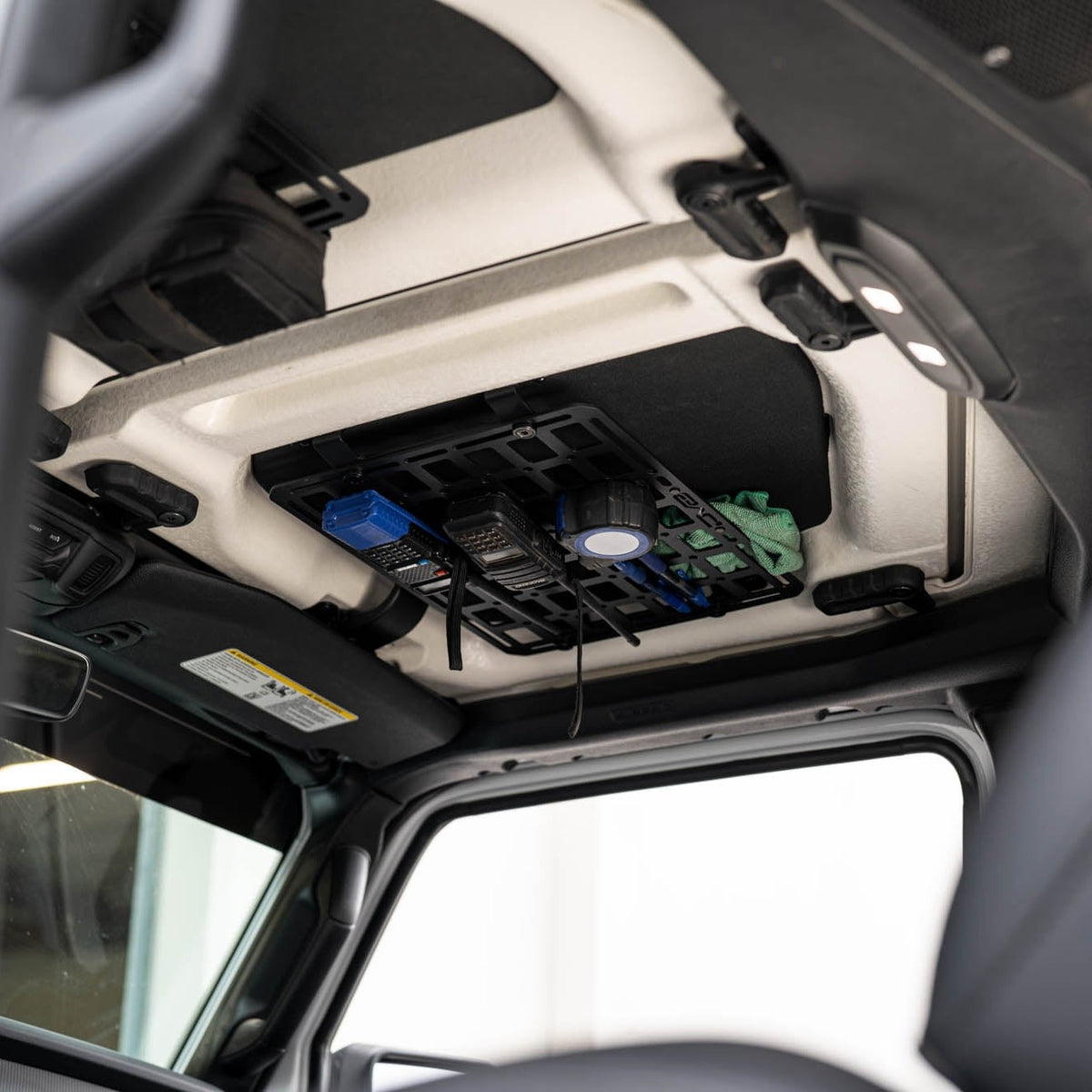 Jeep Wrangler JL Roof Mounts with 15” x 12” Molle Panel installed with radios and tape measure