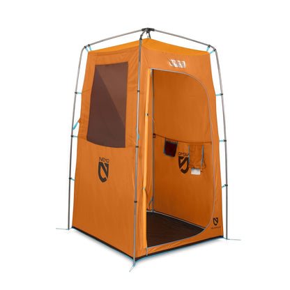 The NEMO Equipment Heliopolis™ Privacy Shelter & Shower Tent is an orange, portable shelter with a zippered door, mesh window, hanging storage pockets, and sturdy metal frame—ideal for use with Helio portable showers on outdoor adventures.