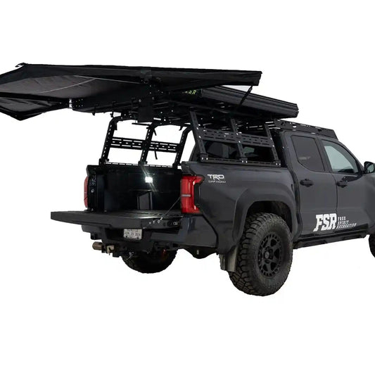 FSR 180 Tailgate Awning mounted and deployed at the rear of a black Toyota Tacoma overlanding setup for use as a rear car awning