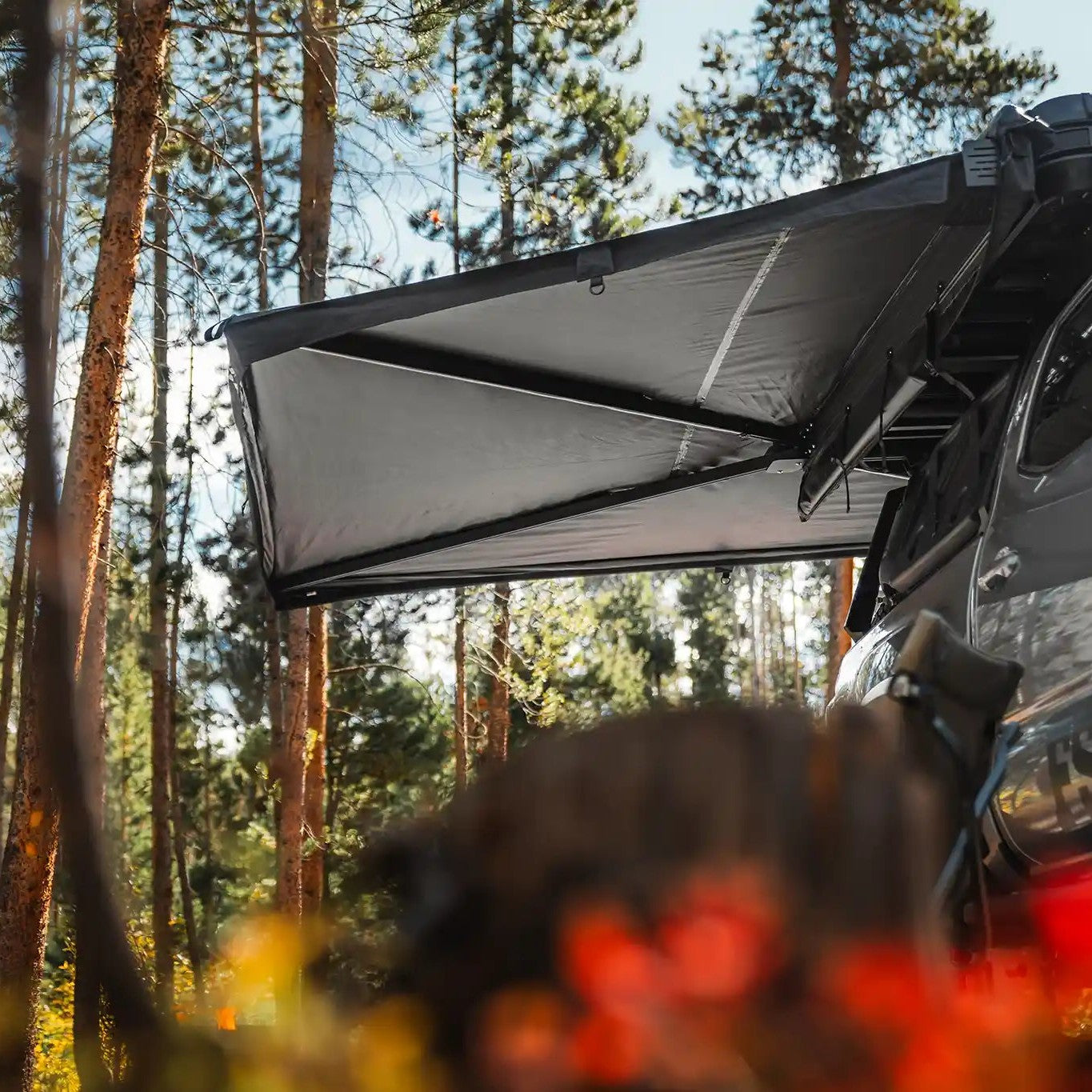 FSR 270 overland awning installed on a gray Toyota Tacoma deployed while camping in a forested campsite