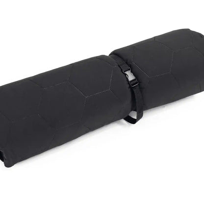 Close up of the FSR Anywhere Camping Mat rolled up with storage strap on a white background