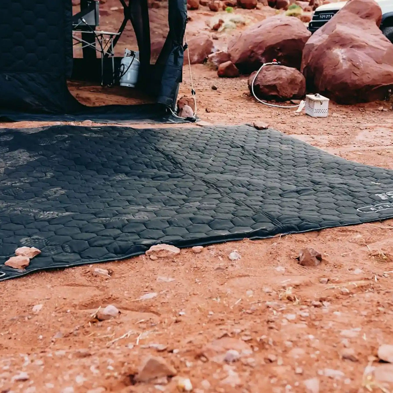FSR Anywhere Camping Mat setup as a ground pad while camping in the desert with a Free Spirit Recreation Hub Series pop-up camping tent in the background