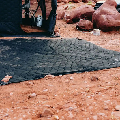 FSR Anywhere Camping Mat setup as a ground pad while camping in the desert with a Free Spirit Recreation Hub Series pop-up camping tent in the background