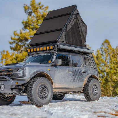 Exterior photo of the FSR Aspen Lite XL Rooftop Tent showing the included crossbars for cargo storage and mounting.