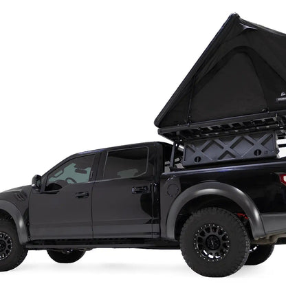 Lower angle photo of the FSR Aspen Lite XL Rooftop Tent by Free Spirit Recreation installed on a black Ford Raptor truck bed rack.